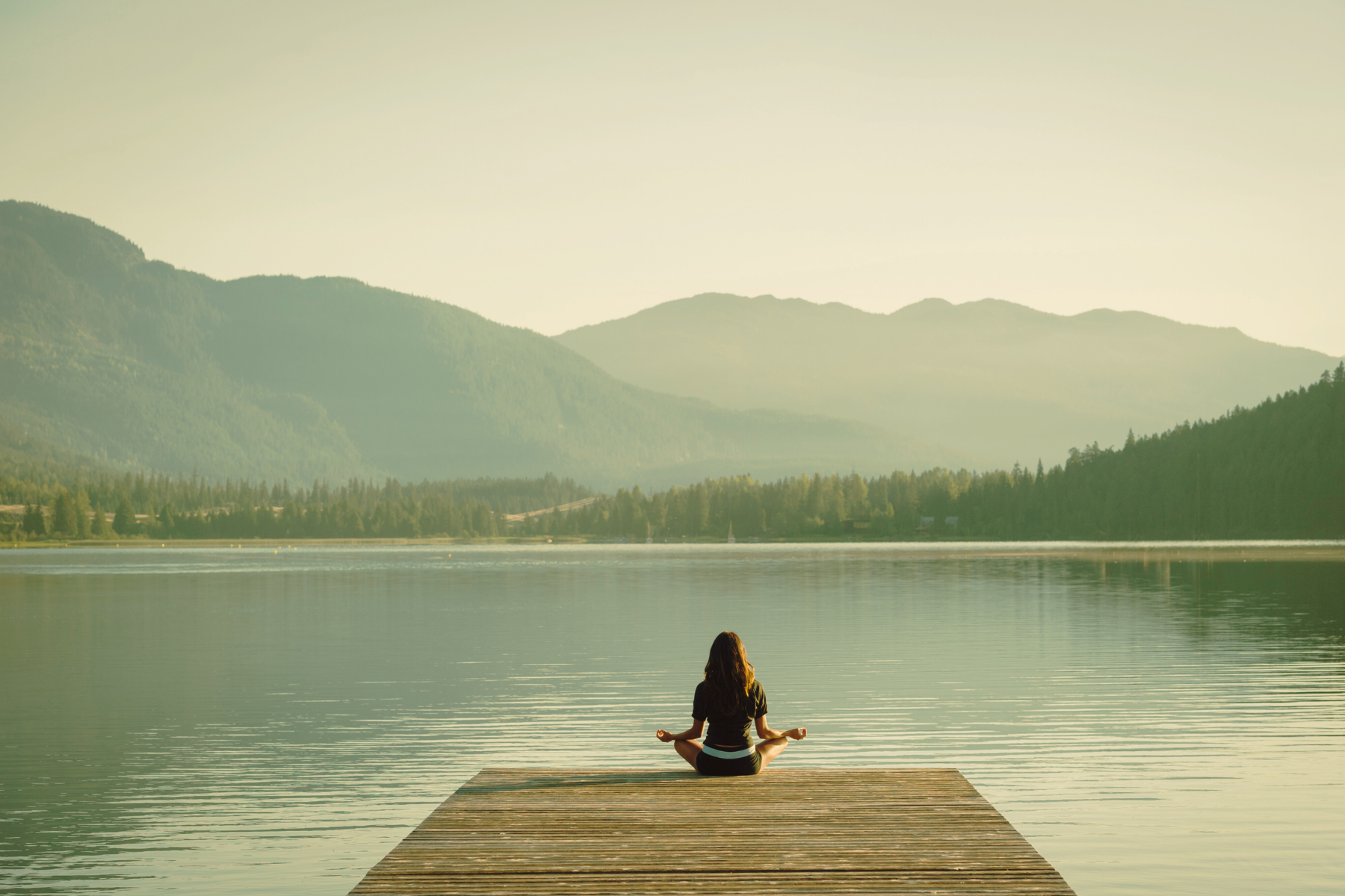 Individual Meditating by Lake