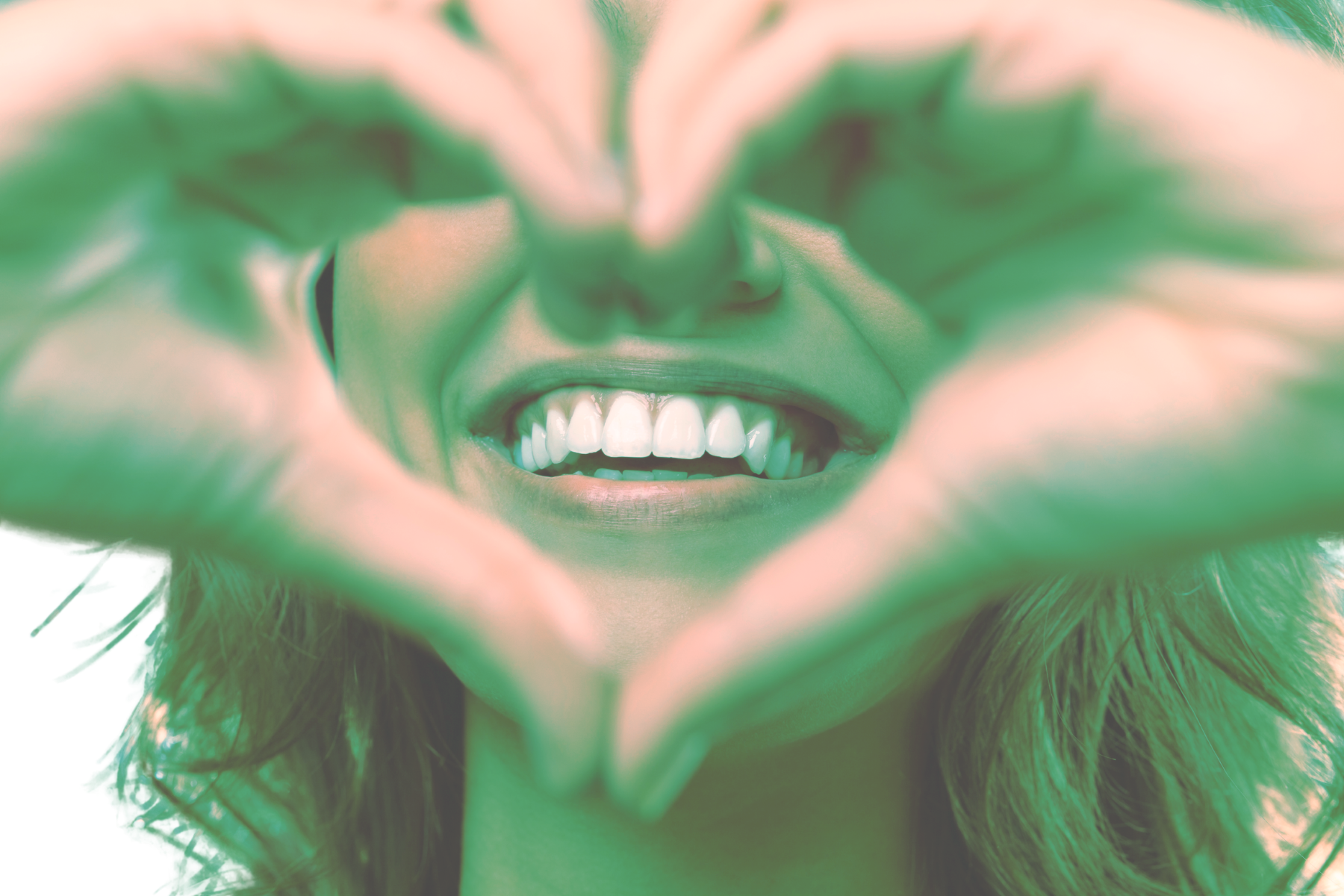 Smiling Face Surrounded by Heart Hands